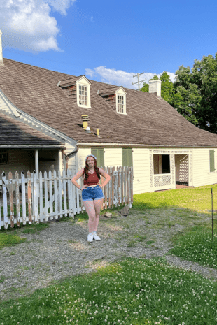 W&J rising senior Ana Giampa stands with her hands on her hips in front of the historic Woodville home in Bridgeville, Pa.